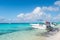 Grand Turk, Turks and Caicos Islands - December 29, 2015: motor boats and people on sea beach. Powerboats on sunny seascape. Trave