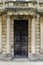 Grand wooden door between stone pillars