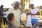 Grandad and dad talking with kids at a family barbecue