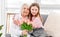 Grandaughter gives flowers to grandmother