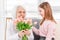 Grandaughter gives flowers to grandmother