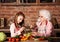 Grandchild girl helps her granny to cook