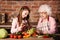 Grandchild girl helps her granny to cook