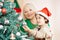 Grandchild helping grandmother to decorate christmas tree