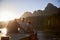 Grandchildren With Grandparents Sitting On Wooden Jetty By Lake