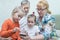 Grandchildren looking at grandmother smartphone