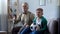 Granddad and grandson watching football together, cheering for favorite team