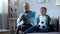 Granddad wrapped in Argentina flag watching soccer with boy, worrying about game