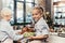 granddaughter assisting for grandmother on kitchen while she preparing