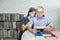 Granddaughter and grandfather reading a book