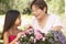 Granddaughter And Grandmother Gardening Together