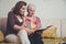 Granddaughter and grandmother looking at old photos