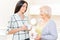 Granddaughter and grandmother standing with cups