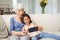 Granddaughter and grandmother taking selfie on mobile phone in living room