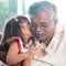 Granddaughter kissing grandfather