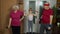 Granddaughter and mature grandparents in sportswear making sports jogging workout exercises at home