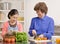 Granddaughter preparing salad with grandmother