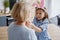 Granddaughter putting on her grandmother a protective mask