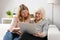 Granddaughter teaching grandma how to use computer