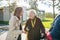 Granddaughter teaching senior woman how to charge new electric car. Progressive grandmother charging her electric