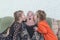 Granddaughters kiss their great-grandmother