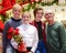 Grandfather and 3 granddaughters standing on stairway decorated for Christmas