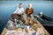 Grandfather with adult son on the picnic on the lake