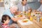 Grandfather assisting grandson while having breakfast