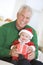 Grandfather With Baby In Santa Outfit