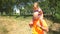 Grandfather carrying grand daughter on shoulders in nature in summer