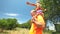 Grandfather carrying grand daughter on shoulders in nature in summer