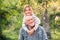 Grandfather carrying his grandaughter on his shoulders.