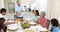 Grandfather carving chicken at dinner table