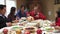 Grandfather Carving Turkey At Family Thanksgiving Meal