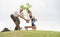 Grandfather and child planting tree in park family togetherness