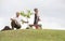 Grandfather and child planting tree in park family togetherness