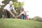 Grandfather and child planting tree in park family togetherness