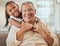 Grandfather, child and portrait with hug in home lounge to bond with young and cute grandchild. Family, elderly and