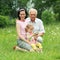 Grandfather, daughter and granddaughter are photographed outdoors.