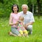 Grandfather, daughter and granddaughter are photographed outdoors.