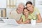 Grandfather, daughter and granddaughter using laptop