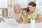 Grandfather, daughter and granddaughter using laptop