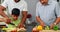 Grandfather and father assisting boy to cut vegetables 4k