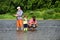 Grandfather, father and grandson fishing together. Family fishermen fishing with spinning reel.