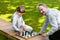 Grandfather, father and kids playing chess