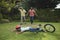 Grandfather and father running towards fallen boy with bicycle