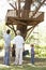 Grandfather, Father And Son Building Tree House Together