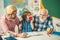 Grandfather and father teaching son. Granddad and cute little boy grandson study and learn together. Senior grandpa and