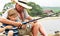 Grandfather fisher in straw hat and little male grandkid enjoying leisure activity use fishing rod