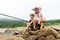 Grandfather fisher in straw hat and little male grandkid enjoying leisure activity use fishing rod